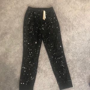 Black sequin joggers. NWT. Satin strip down leg